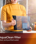 AquaClean filter in clear container for purified water, showcased by a woman wearing a yellow top, enhancing espresso quality.