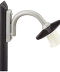 Silver and black wall-mounted outdoor light fixture on wooden post