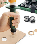 12 In 1 Gasket Punch Set being used to punch a hole in leather, with hollow punches and handle, storage box visible in background