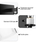 Close-up of Modern Matte Black Wall Sconces Set Of Two Double Clear Glass Vanity Lights, showing metal back and E26 base.