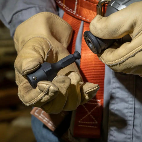 Worker handling NRHDA Hex Quick-Change Socket Adapter For NRHD, 7/16-Inch, Rust-Resistant Black Finish in gloved hands