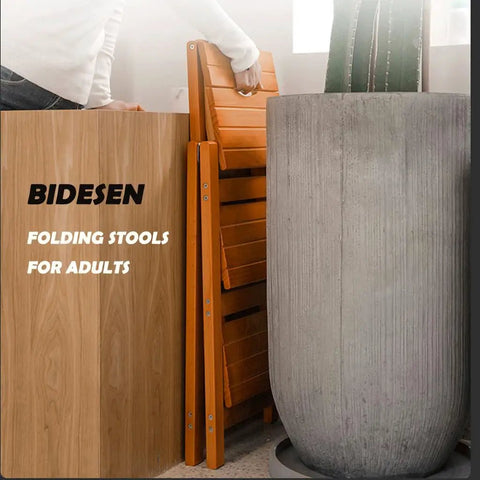 3 Step Wooden Folding Stool Chair With Solid Pine Frame folded next to planter, showing compact storage capability.