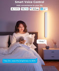Person reading in bed with Smart Wall Sconce featuring RGBICW LED Bulbs, adjustable brightness, cozy atmosphere.