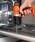 Person using Slotted Phillips Screwdriver Bit Set With Holder 12 Piece 3 Inch Bits Magnetic Drill Bit Set One Quarter Inch Hex For Everyday Home Fixups And Garage Projects Durable Steel in orange cordless drill on metal surface