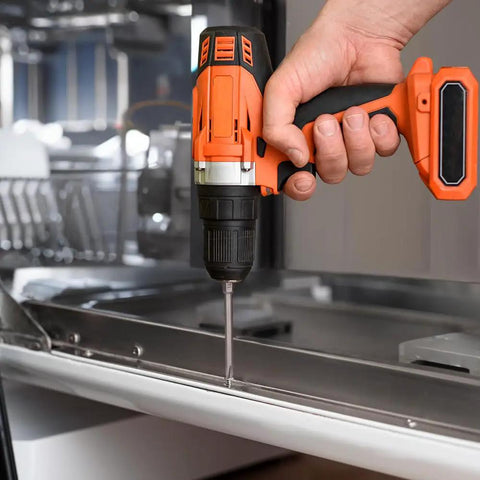 Person using Slotted Phillips Screwdriver Bit Set With Holder 12 Piece 3 Inch Bits Magnetic Drill Bit Set One Quarter Inch Hex For Everyday Home Fixups And Garage Projects Durable Steel in orange cordless drill on metal surface