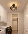 Black Flush Mount Ceiling Light With Dope Metal Cage Design And Industrial Vibe For Hallways Kitchens Porches And Bedrooms Vintage Farmhouse Style That Casts Dramatic Shadows When On And Elevates Any Ceiling Space in laundry room