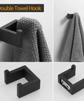 Matte Black Stainless Steel Finish 4 Piece Bathroom Accessory Set Includes 24 Inch Towel Bar, Hand Towel Holder Towel Rack, Toilet Paper Holder, And Double Towel Hooks For Wall Mounted Bath Hardware shown with a towel on it