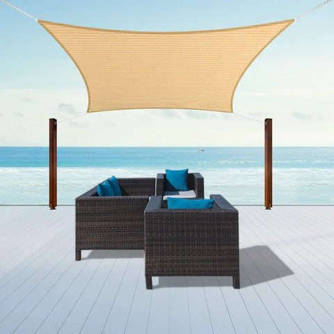 Beige 6 By 8 Foot Sun Shade Sail Canopy Awning over patio with wicker chairs and ocean view