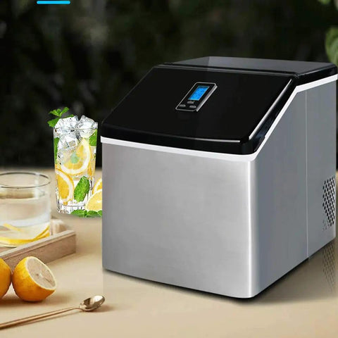 Compact Countertop Ice Maker Cranks Out 24 Frosty Cubes In Under 20 Minutes With A 2.2L Quick Pour Tank And Zero Fuss Self Clean Design Built From Safe Bpa Free Abs Plastic For Instant Backyard Chill Vibes next to a refreshing drink.
