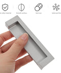 Hand holding 2-Piece Black Recessed Drawer Pull Handles Zinc Alloy Concealed Furniture Hardware For Cabinets, Wardrobes, And Sliding Doors Replacement