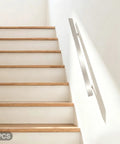 Heavy Duty Flush Handrail Set Wall Mount Stainless Steel Stair Railing Kit on stairs with wood steps and white wall.