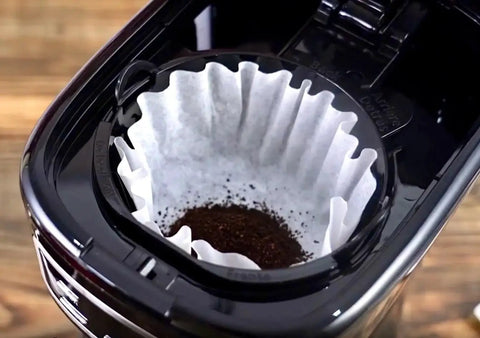 Sleek Black 12 Cup Programmable Drip Coffee Maker With Bold Brew Control auto timer with filter and coffee grounds.