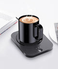 Keep Your Brew Dialed All Day With This 43 Ounce Electric Heating Mug Featuring Smart Three Level Temp Control Super Long Battery Ceramic Bottom Plate And Desk Warmer Made For The Daily Office Grind, black ceramic mug on warming plate with steaming coffee.