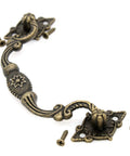 4 Pack Vintage Antique Brass Bail Pull Handles For Wooden Drawers Cabinets And Cupboards, showing one handle with screws.