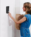 No Drill Stick-On Door Mount For 1st Gen Video Doorbell on a white door with woman interacting, adhesive mount bracket in use