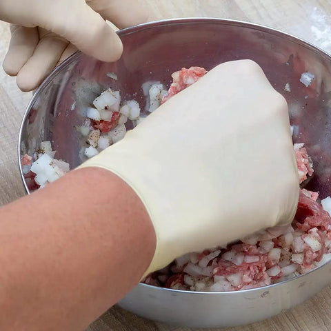 Top Notch Latex Disposable Gloves With Corn Starch Powdered Finish For Food Handling And Light Industrial Chores Smooth As Butter X Large mixing meat in a bowl.