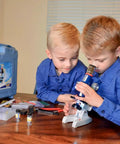 Two children using Hands On Kids Microscope Kit With 100X To 1200X Magnification Metal Body LED Light Carrying Case 58 Piece STEM Toy