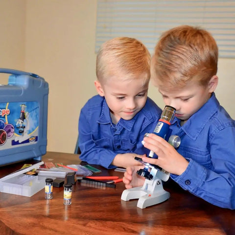 Two children using Hands On Kids Microscope Kit With 100X To 1200X Magnification Metal Body LED Light Carrying Case 58 Piece STEM Toy
