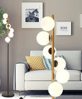 Six Globe Floor Lamp With Glass Shade Tall LED Pole Light In Black And Gold Finish Mid Century Modern Style in living room