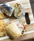Pre Cut Pop Up Aluminum Foil Sheets 14 By 10.25 Inches Pack Of 50 For Quick No Mess Wrapping And Easy Lift with wrapped sandwich on board