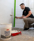 Man applying heavy duty elastomeric liquid rubber coating for block and wall waterproofing 5 gallon white pro grade sealant