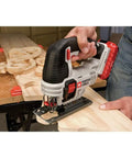 User operating Shop Tested 20V Max Cordless Jigsaw With Built In Dust Blower and Easy Swap Blade Clamp on wood.