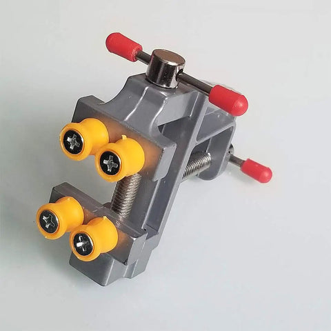 Rock Solid Mini Bench Vise Slick Portable Aluminum Table Clamp With Adjustable Jaw Pins on a table for precision part holding.