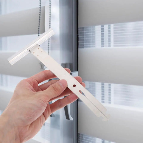Four Piece Heavy Gauge Roller Shutter Spring Replacement Kit Built From Top Shelf Stainless Steel, hand holding a white installation tool.