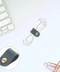 Five Piece Leather Cord Wraps Keep Your Computer Rig Hella Neat With Durable Sock Style Cable Organizers For Usb Chargers Phone Wires And Audio Equipment, dark green strap securing white wires.