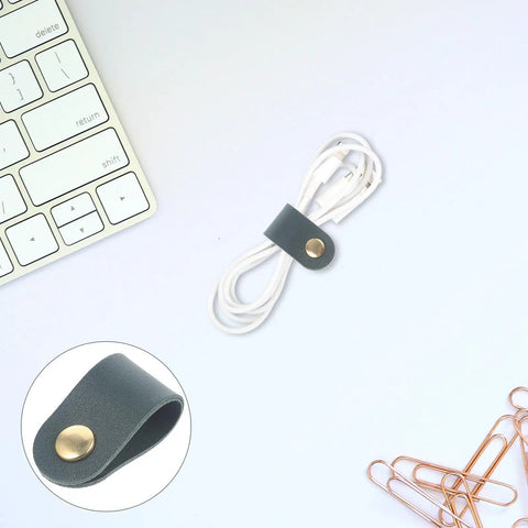 Premium Cable Organizer Straps with dark green fastener holding white headphone wires, neatly arranged beside a keyboard.