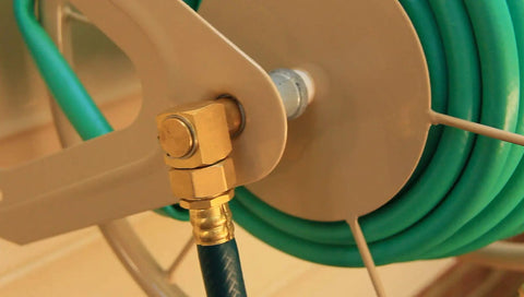 Close-up of Built Tough Heavy Duty Steel Garden Hose Reel Wall And Floor Mount, hose coiled on industrial grade tan reel