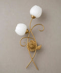 Decorative gold wall sconce with floral design and white glass shades; not the Gold Wall Sconces Set Of Two With Thick Clear Glass Shades