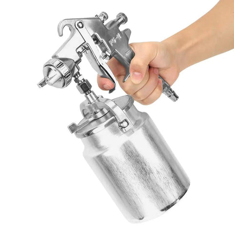 Premium Pneumatic Paint Spray Gun Featuring 2.0 Mm Suction Feed Nozzle in hand, showcasing 1000CC cup and ergonomic design.