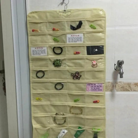 Keep Your Jewels In Check with This Double Sided Hanging Jewelry Organizer featuring 80 transparent pockets for accessories.