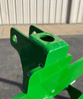 Close-up of No Hassle Dual Mount Tractor Pallet Forks mounting bracket showing two inch receiver tube in bright green finish.