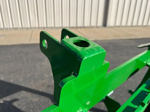 Close-up of No Hassle Dual Mount Tractor Pallet Forks mounting bracket showing two inch receiver tube in bright green finish.