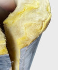 Close-up of yellow rock wool fibers in a Heavy Duty Rock Wool Pipe Shell High Temperature Insulation with aluminum foil cover.