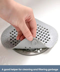 Heavy Duty Two Pack Square Hair Drain Catcher And Tub Filter With Grip Tight Suction Pads To Keep Your Shower Bathtub And Kitchen Sink Totally Clear Grey being removed from a drain.