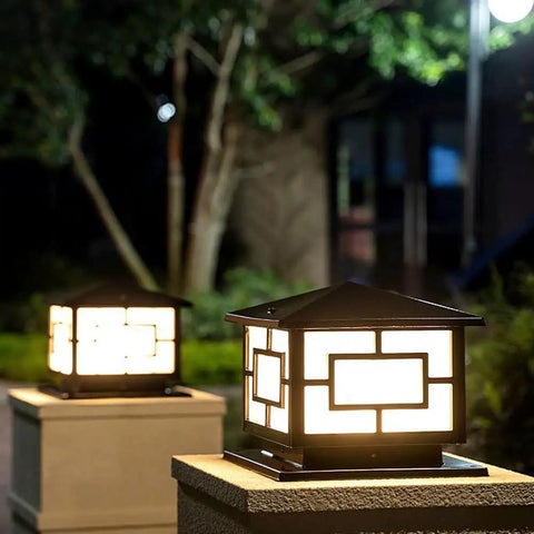 Outdoor Pillar Lights Modern Rustic Aluminum Post Lights with glass shade illuminating a garden path at night