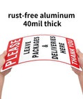 Leave Your Packages Here Heavy Duty Aluminum Front Porch Drop Off Sign 12X8 Inches held in hands showing 40mil thickness.