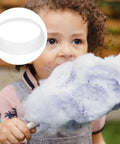 Child eating cotton candy with inset showing Cotton Candy Machine Guard Cover Enclosure For Portable Mini Candy Makers White Plastic Shield To Prevent Messes And Spills Durable Candy Maker Accessory With Sugar Dispenser Part For Home Kitchen Use.