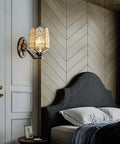 Solid Brass Wall Sconces With Glass Lantern, vintage wall sconce mounted beside a bed, stylish lighting fixture in bedroom.