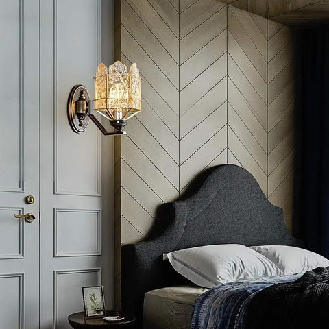 Solid Brass Wall Sconces With Glass Lantern, vintage wall sconce mounted beside a bed, stylish lighting fixture in bedroom.