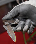 Klein Tools 44228 folding pocket knife; side view, black handle, stainless blade, bearing-assisted flipper, belt clip.