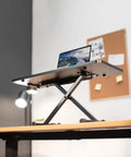 Black 28 Inch Standing Desk Converter Sit To Stand Monitor Riser With Scissor Lift Height Adjustment shown on office desk