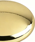 Close-up of solid vintage unlacquered brass dome cabinet knob for kitchen or bathroom installations.
