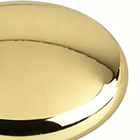 Close-up of solid vintage unlacquered brass dome cabinet knob for kitchen or bathroom installations.