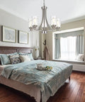 Five Light Modern Chandelier in Brushed Nickel Finish With Clear Hammered Glass Pendants hanging above bedroom