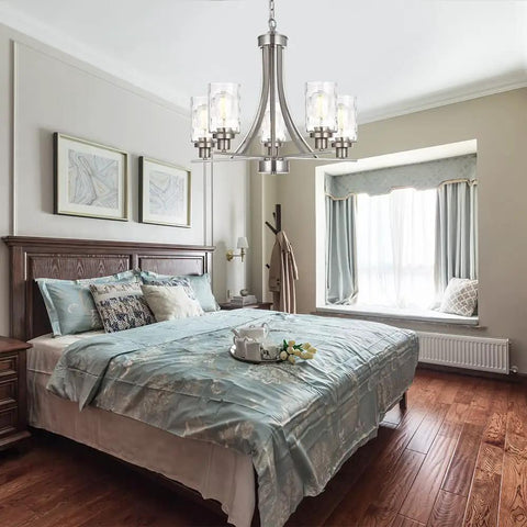 Five Light Modern Chandelier in Brushed Nickel Finish With Clear Hammered Glass Pendants hanging above bedroom