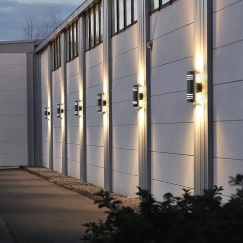 Dusk To Dawn Outdoor Wall Lights 2 Pack Up Down Cylinder Black Porch Sconces illuminating a modern garage exterior
